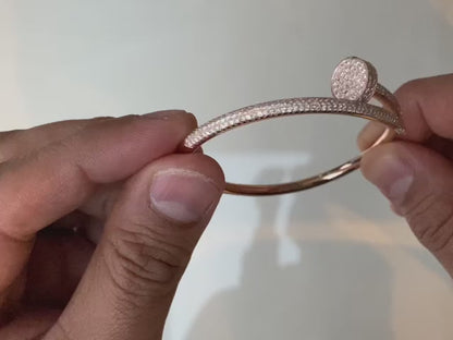 "The round bangle adorned with a sparkling zircon stone."